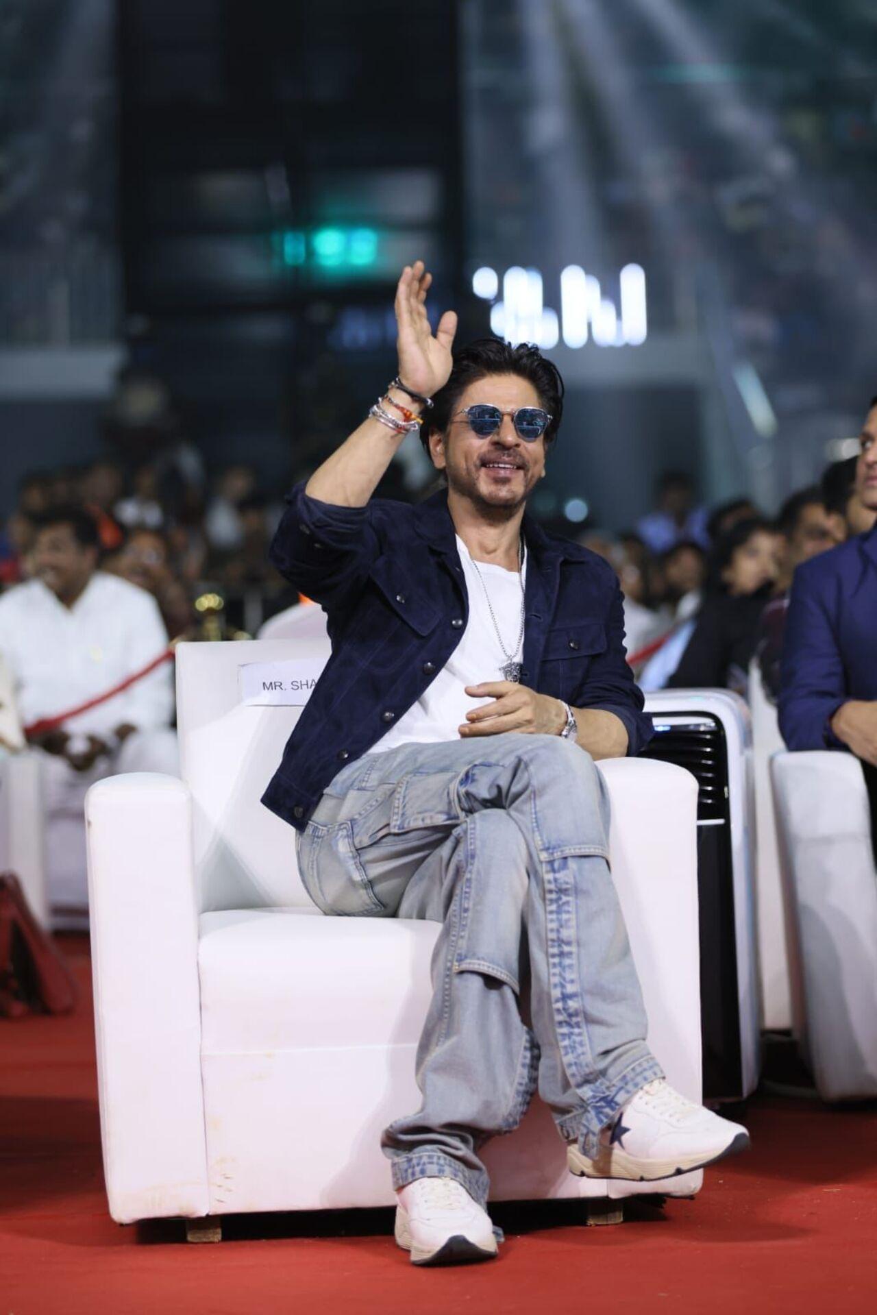 Shah Rukh Khan attended the pre-release event of Jawan in Chennai immediately after his visit to the Vaishnodevi shrine. He looked dapper in a white T-shirt and blue jacket
